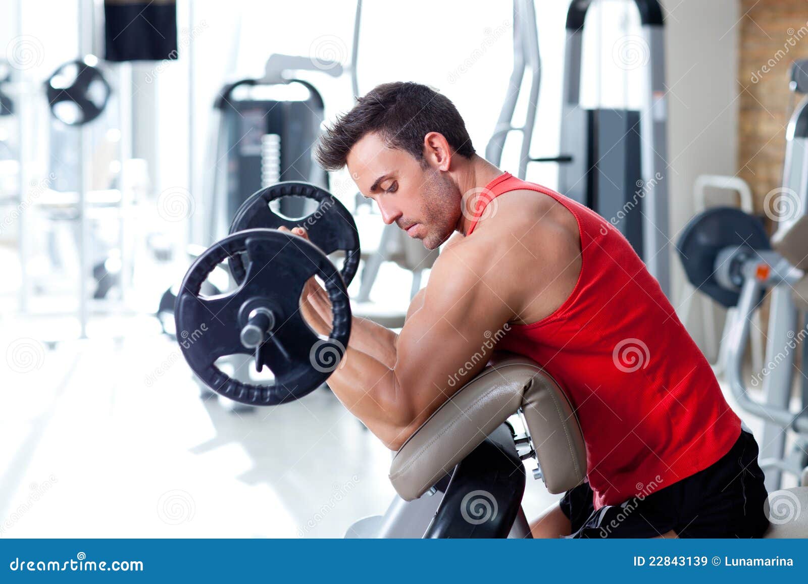 man with weight training equipment on sport gym