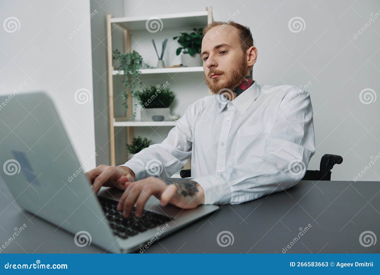A Man in a Wheelchair a Businessman with Tattoos in the Office Works at a  Laptop, Integration into Society, the Concept Stock Image - Image of  coffee, illness: 266583663