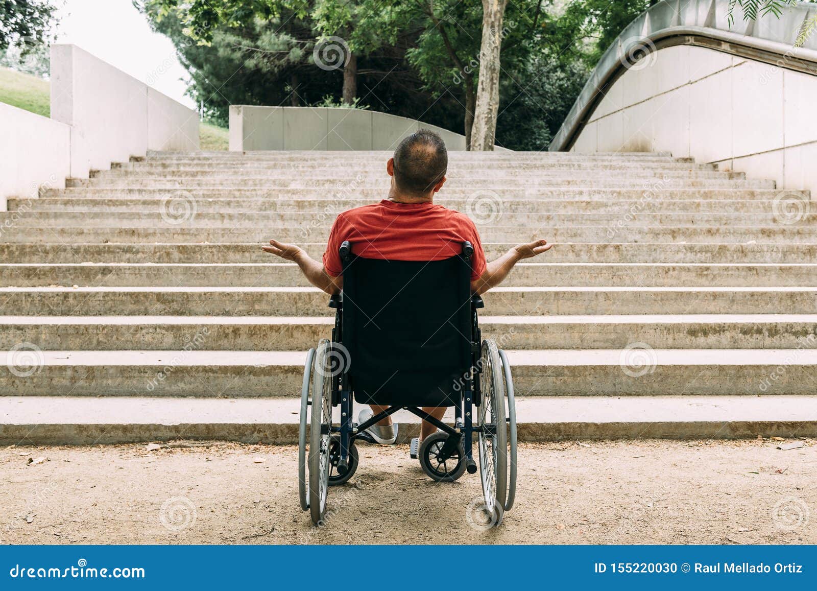 man in wheelchair outraged in front of stairs