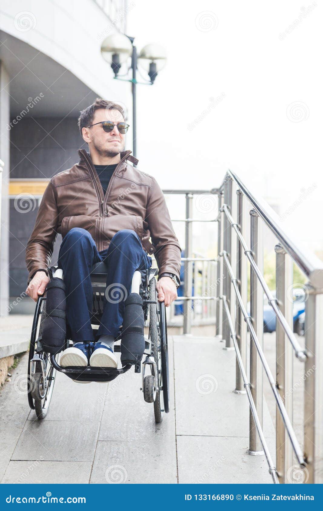 Man in a Wheelchair Use a Wheelchair Ramp. Stock Photo Image of