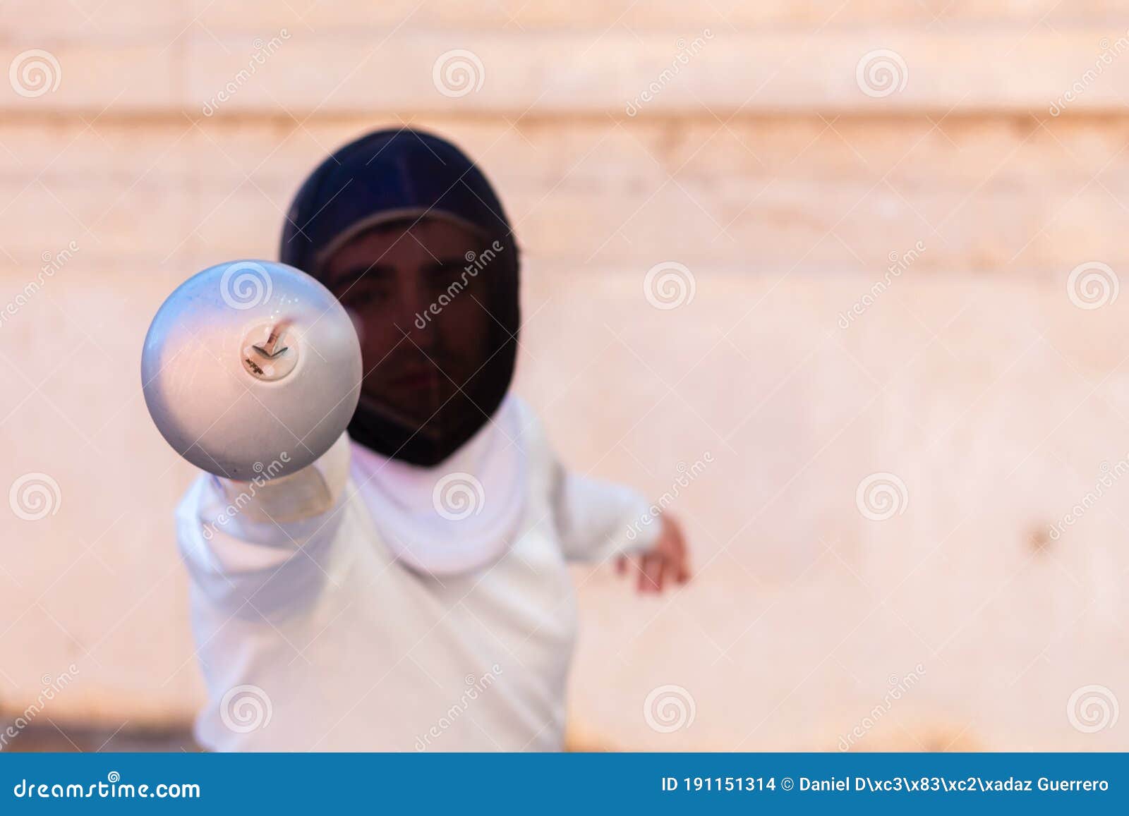 Man in White Fencing Suit and Black Fencing Mask Standing with Sword