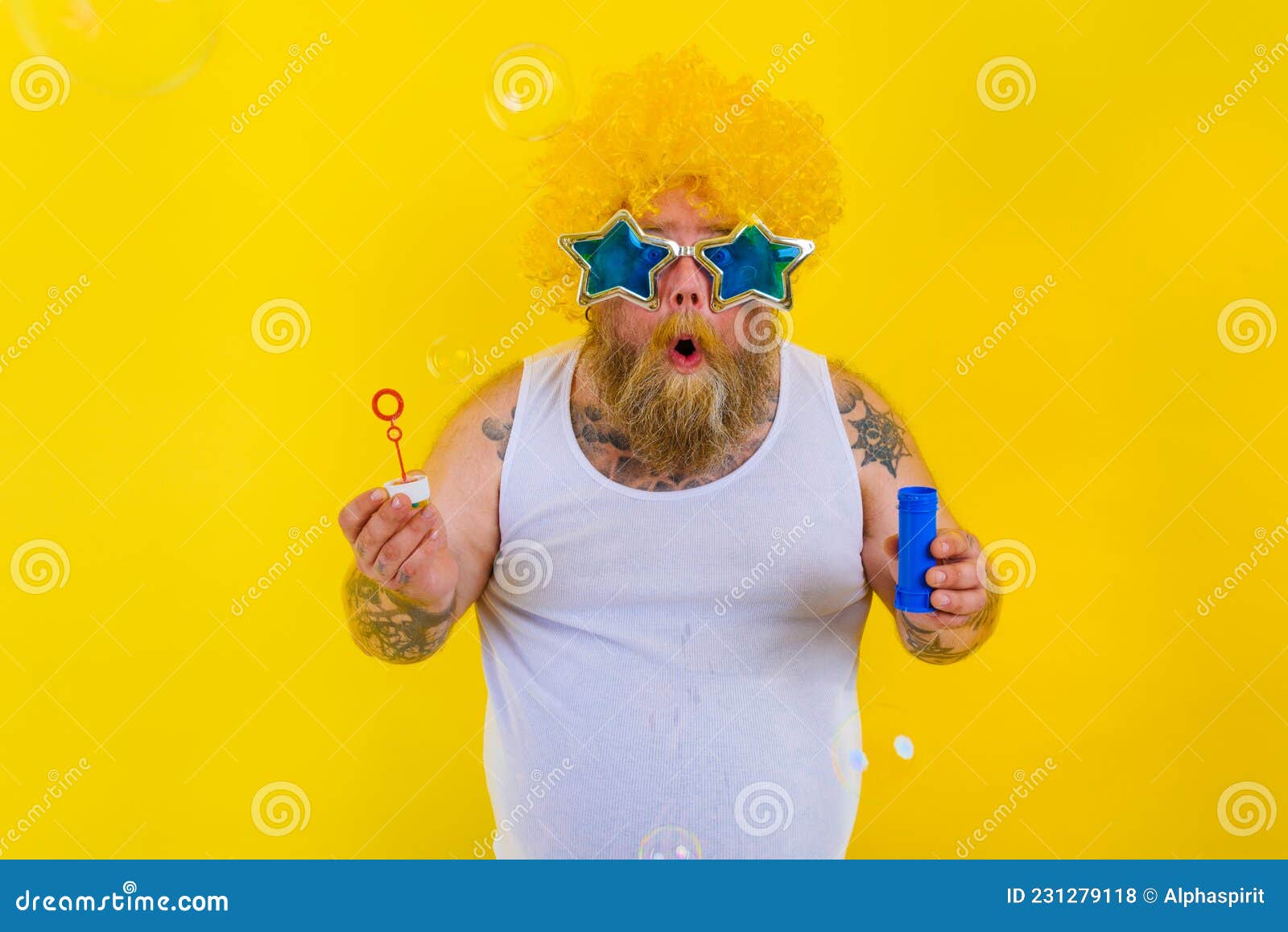 Amazed Man with Yellow Wig in Head Play with Bubbles Soap Stock Photo