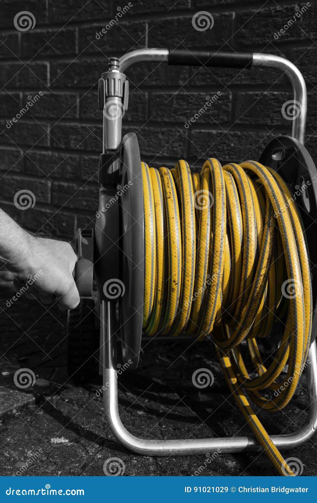 Man Winding a Hose Pipe Reel Stock Image Image of pipeline, reel