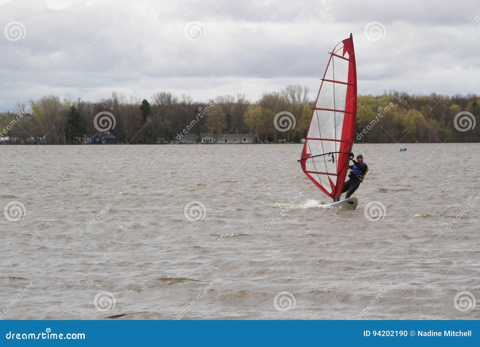 Man windsurfing on a board editorial image. Image of lake 94202190