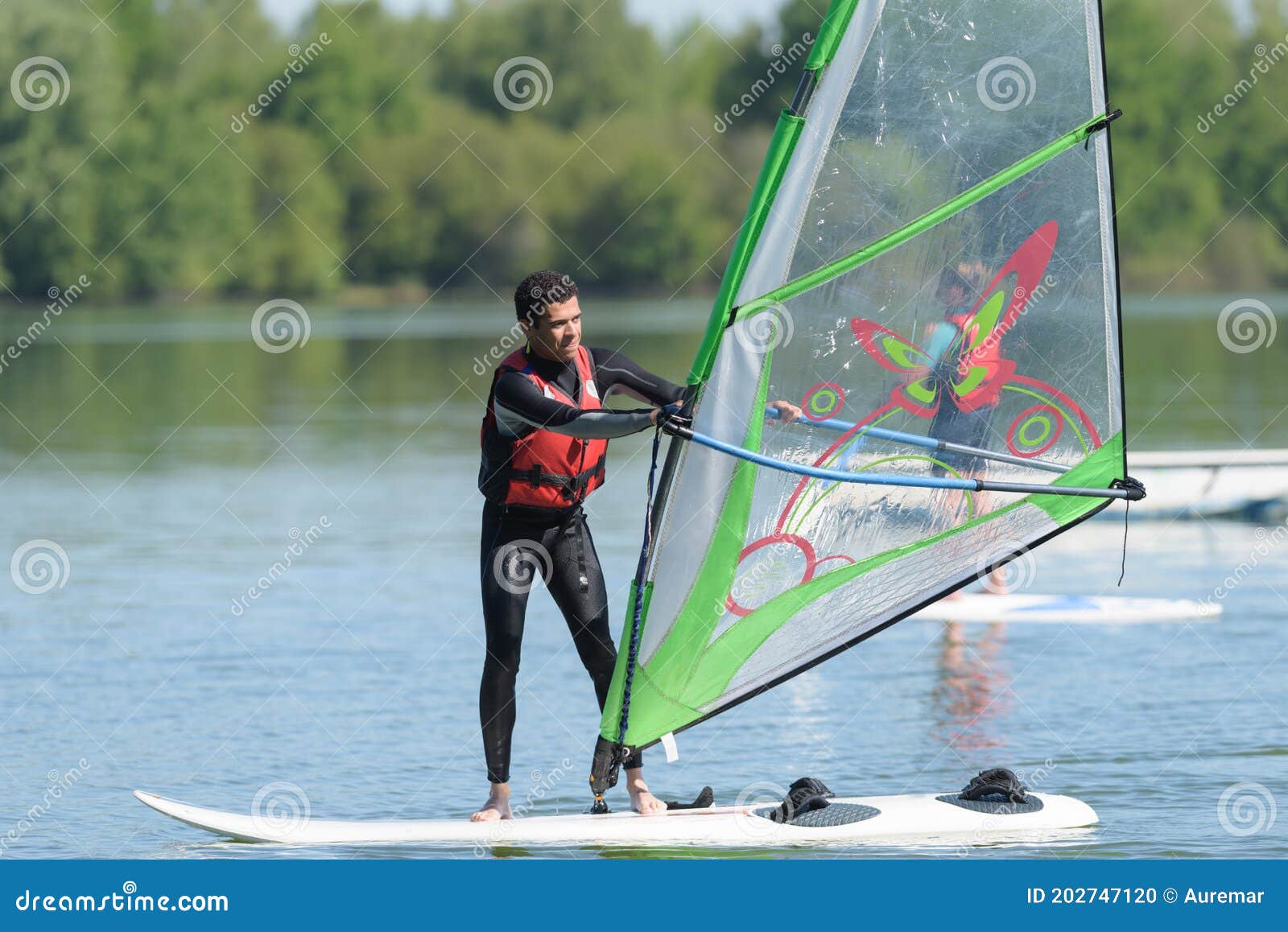 Man windsurfing on lake stock photo. Image of sport 202747120
