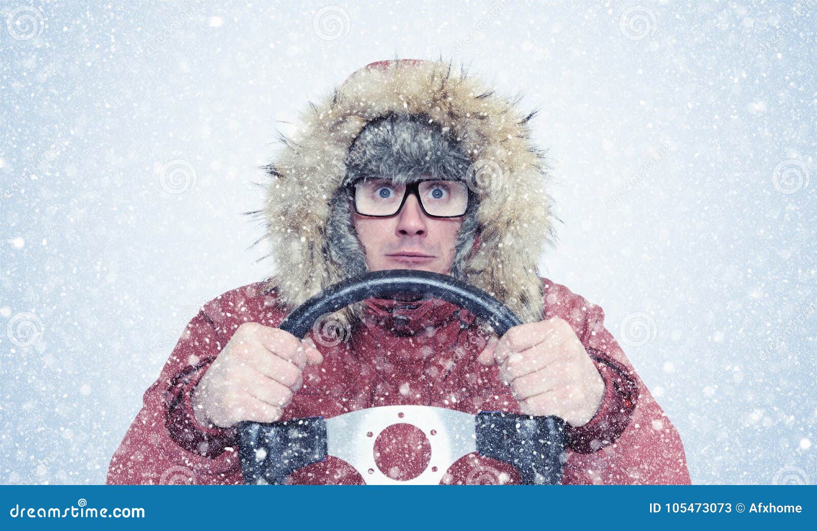 man in winter clothes with a steering wheel, snow, blizzard. concept car driver