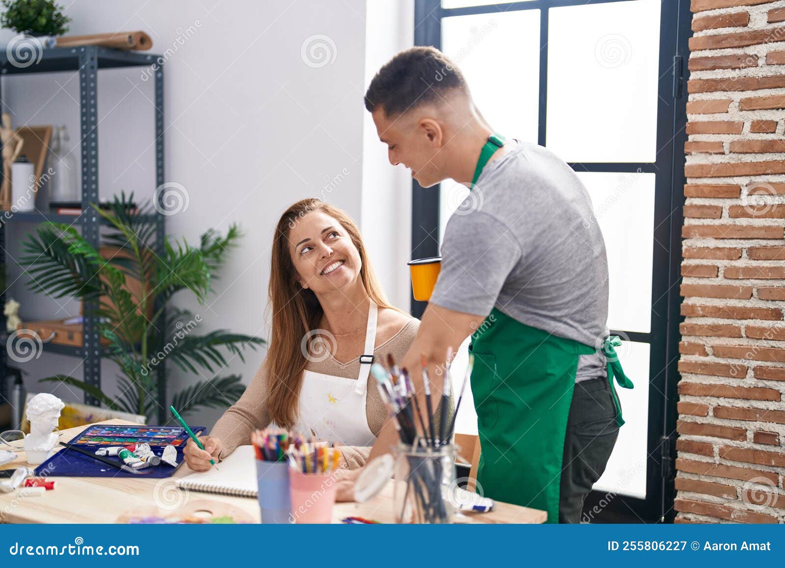 Man and Woman Artists Drawing on Notebook Drinking Coffee at Art Studio