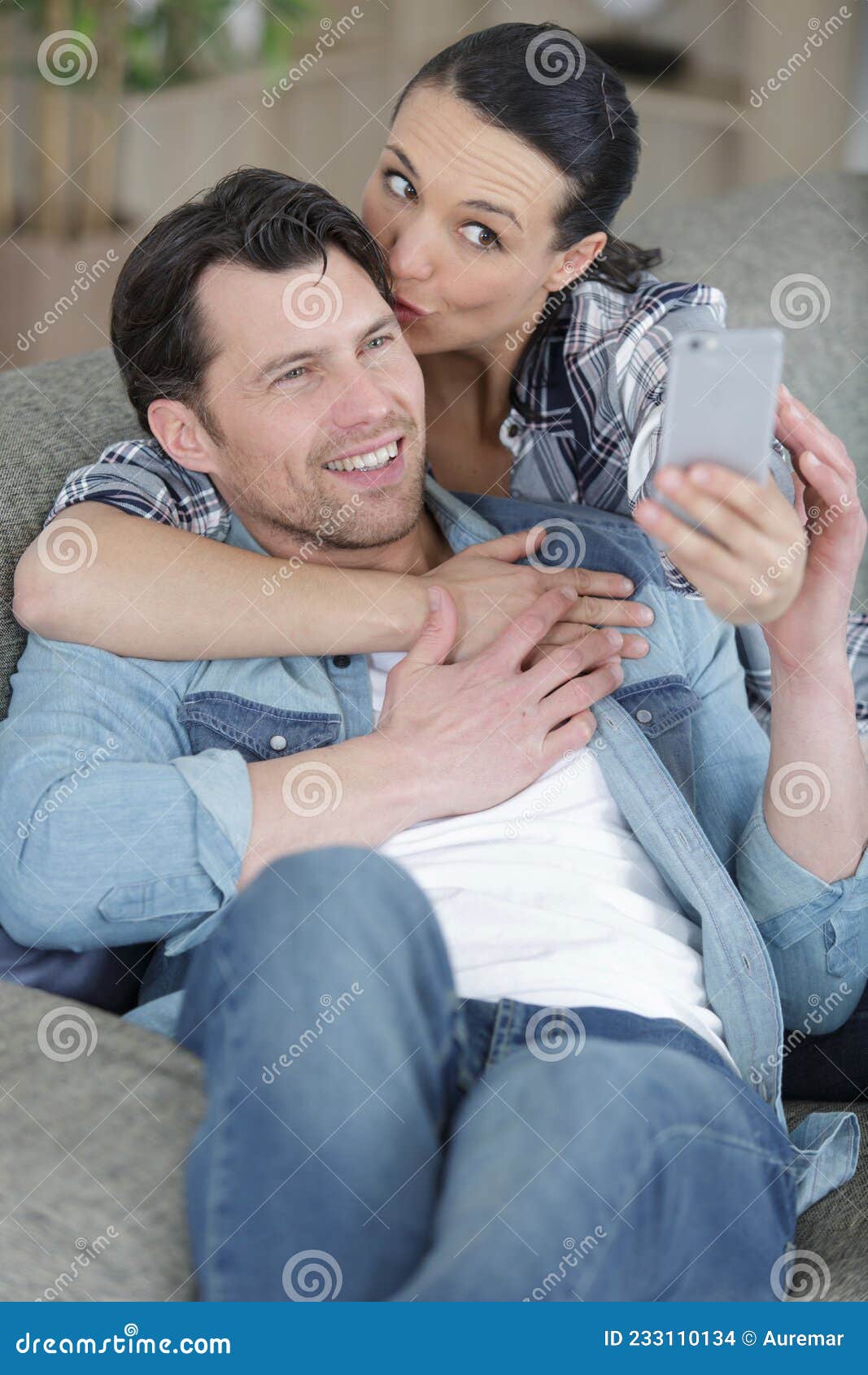 man and woman doing selfie at home