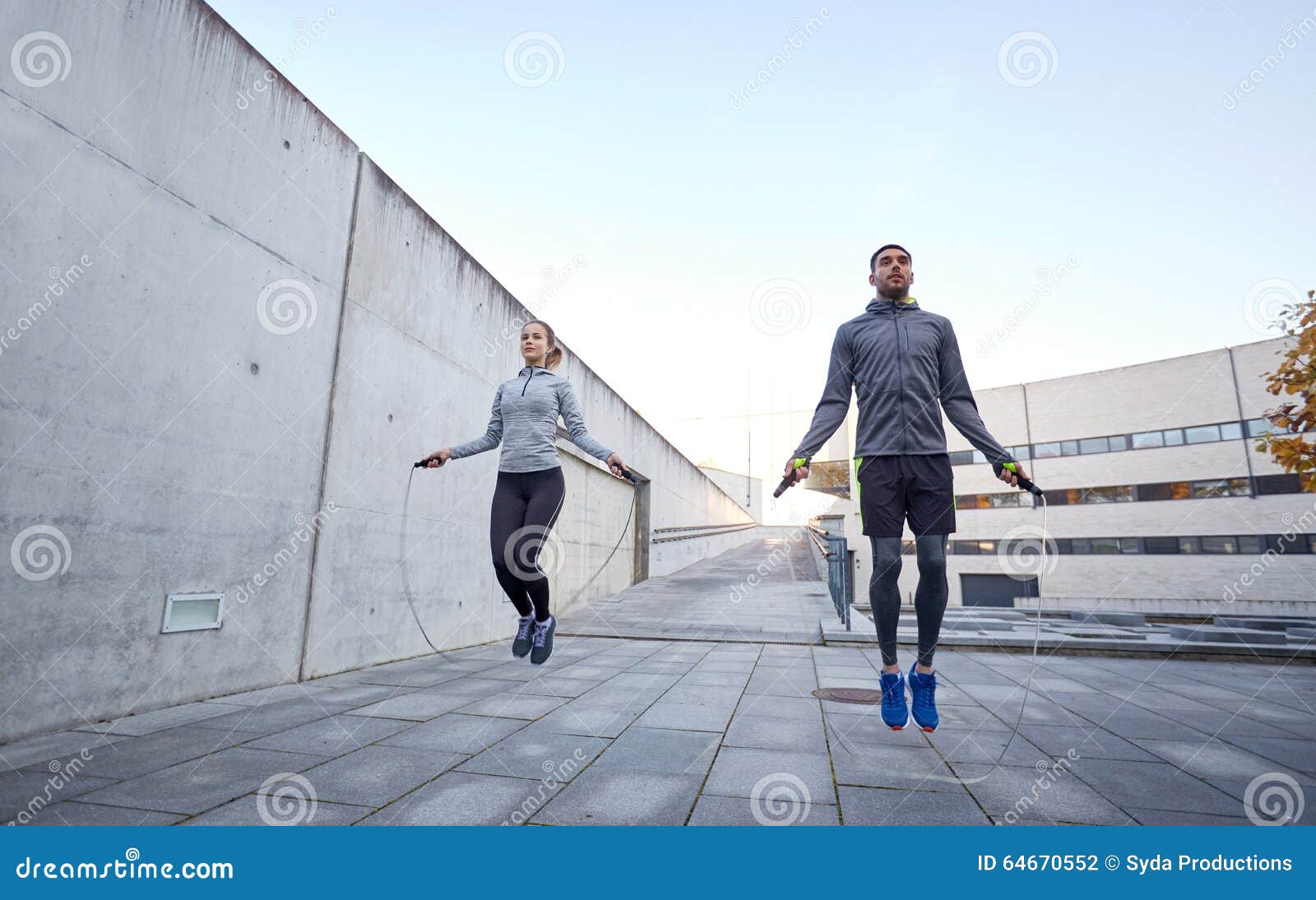 man and woman exercising with jump-rope outdoors