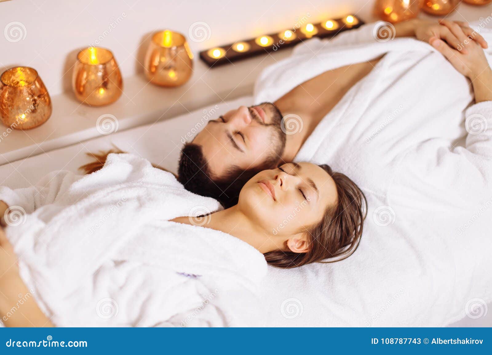 Man And Woman Lying Down On Massage Beds At Luxury Spa And Wellness