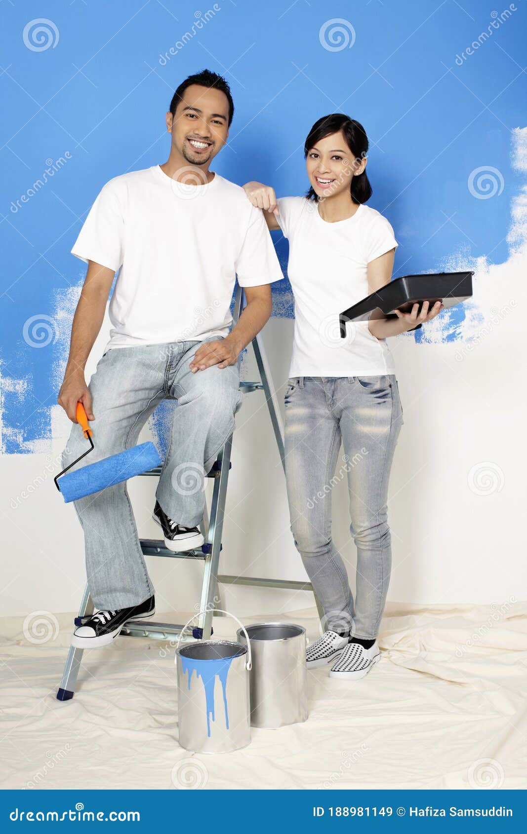 Man and Woman with Paint Roller and Paint Tray. Conceptual Image Stock