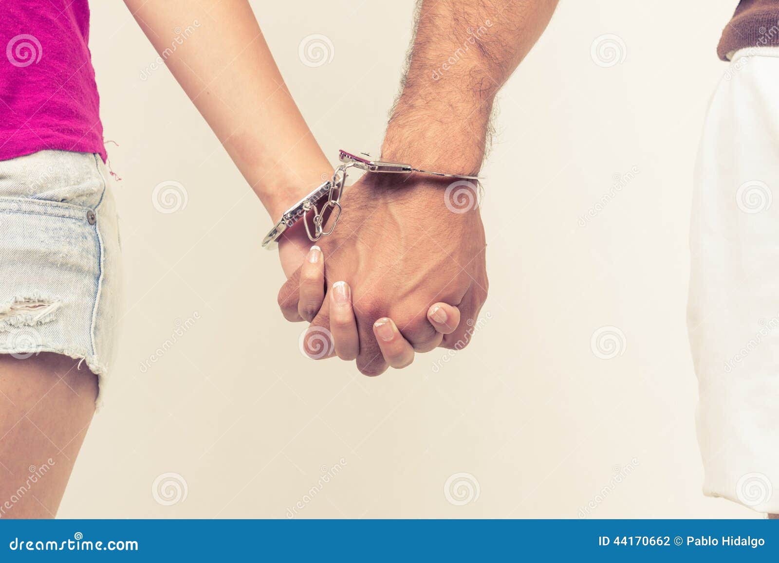Man and Woman S Hands Handcuffed Together Stock Photo image