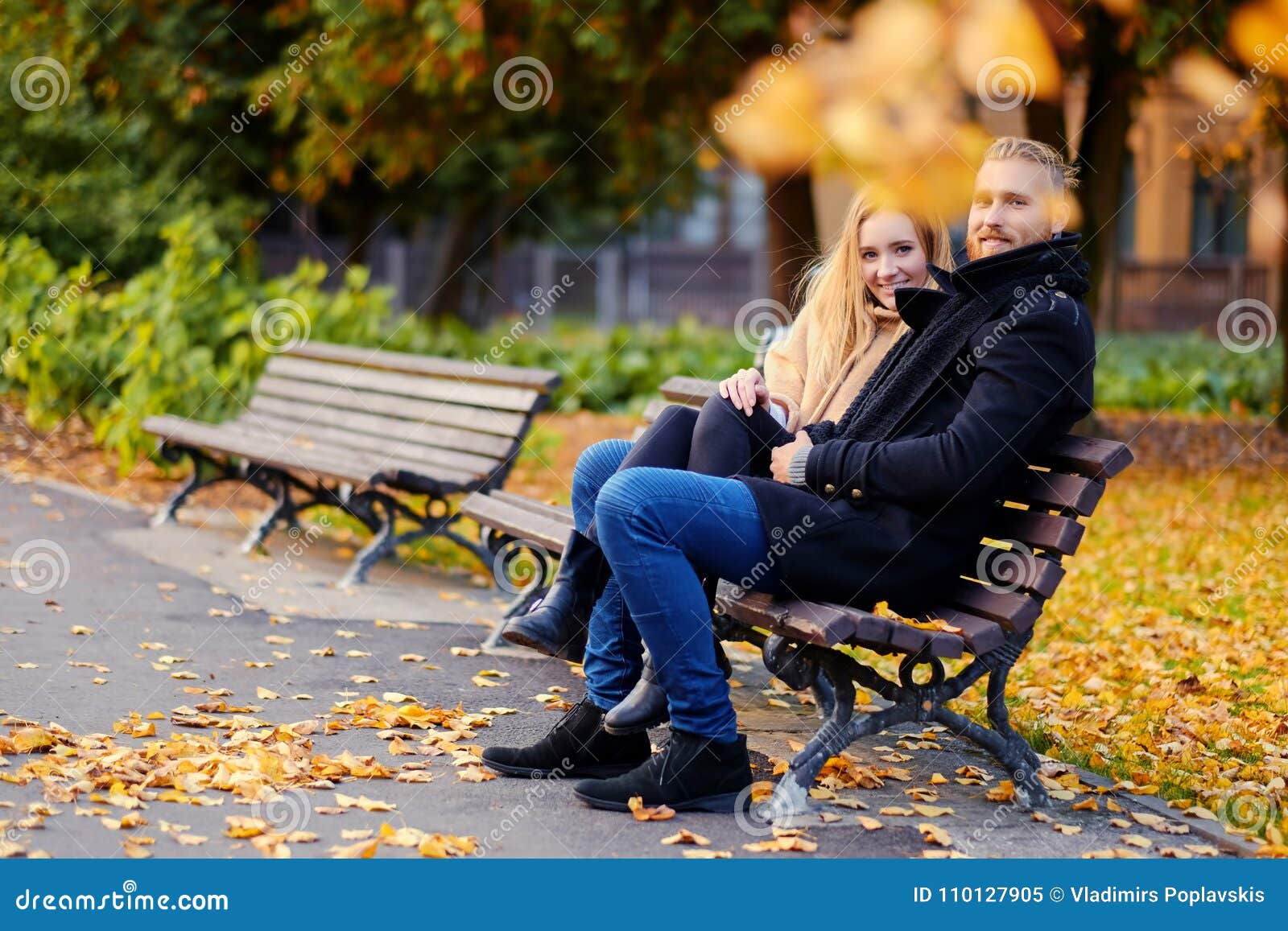 A Man and a Woman Sits on a Bench. Stock Image - Image of attractive ...