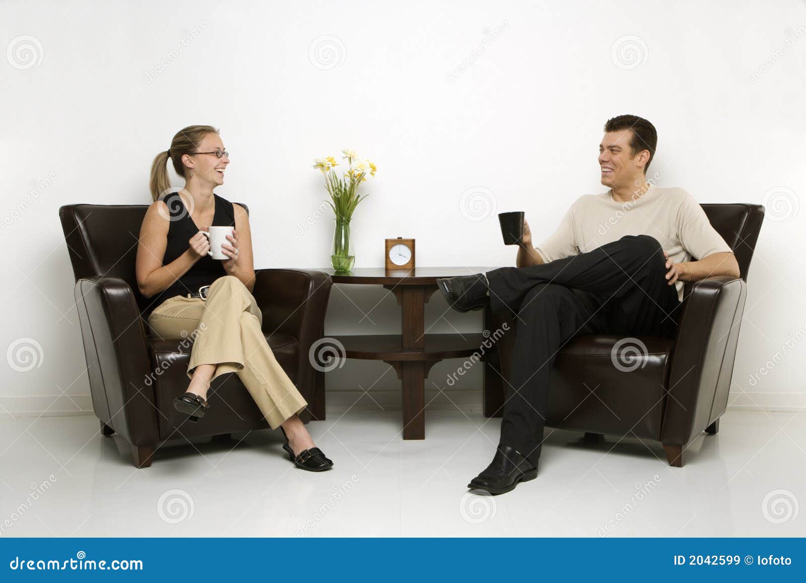 man and woman sitting drinking coffee.