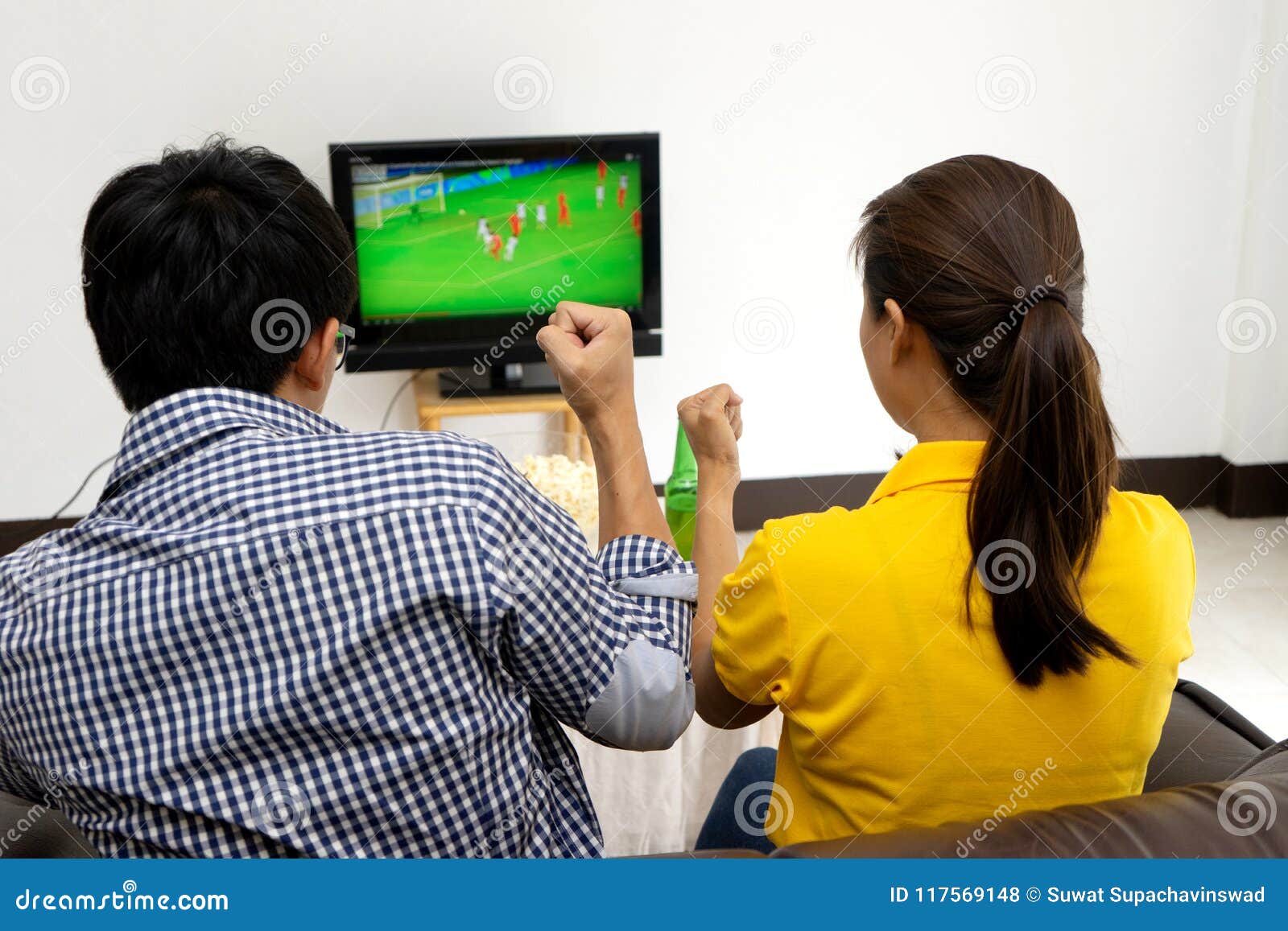 Man and Woman Watch Football Match on Tv Stock Photo