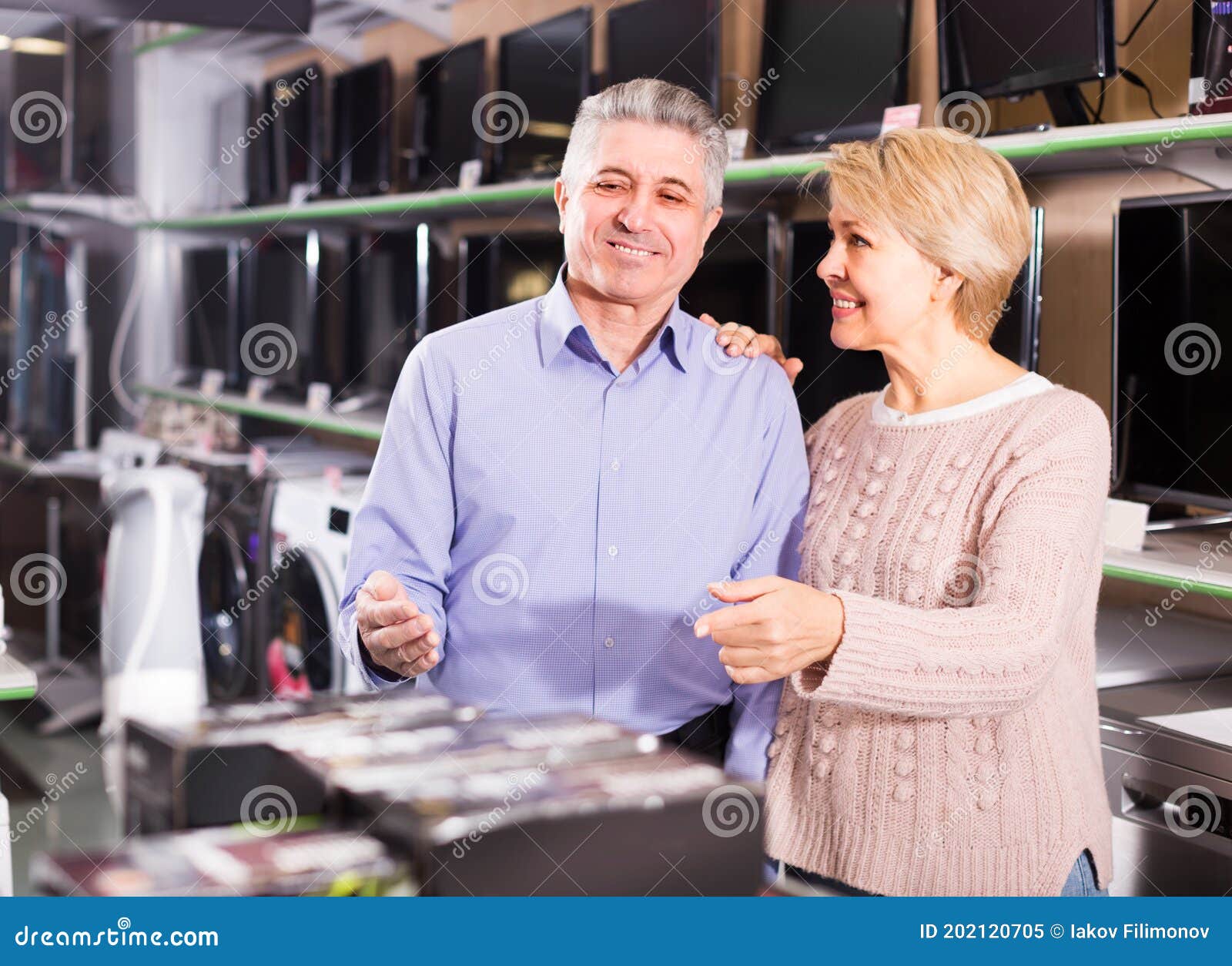 man and woman 49-54 years old are choosing consumer electronics