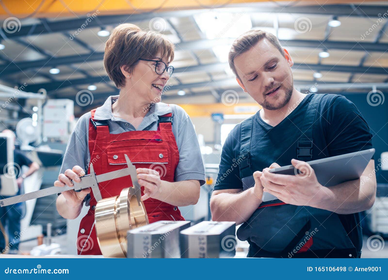Worker In Metalworking Plant Installing A Rivets Into Part For
