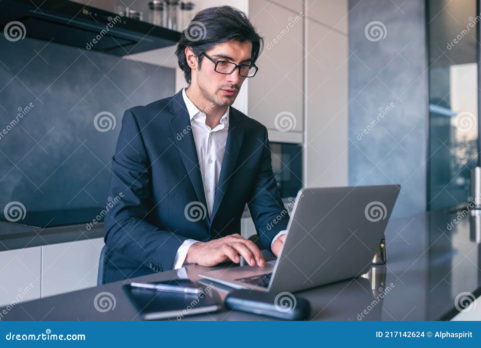 elegant businessman works from home with a laptop. teleworking concept