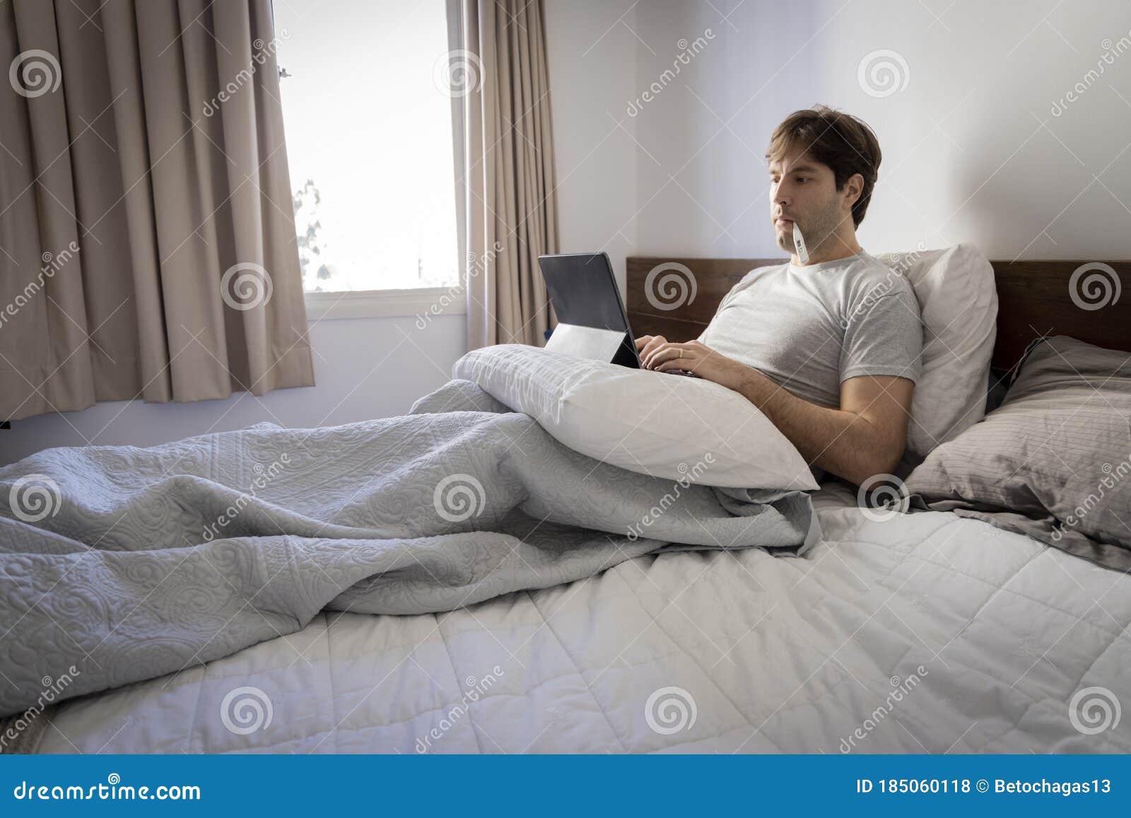 Man Working in Bed, Doing Home Office because he is Sick Stock Photo Image of call, computer