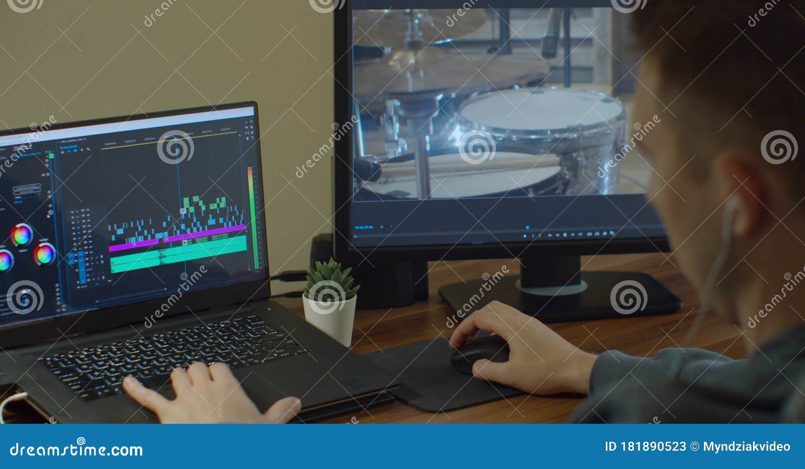 Man Working on Computer with Two Monitors Video Editing. Monitor the