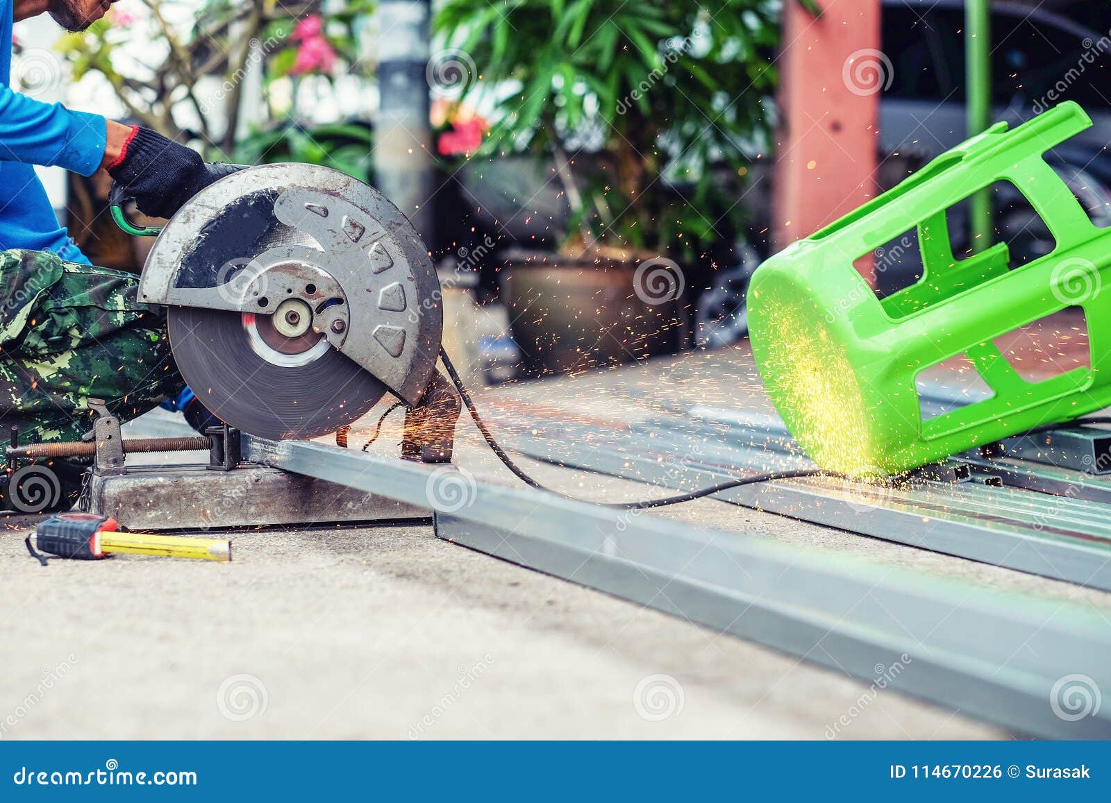 The Man Working on Cutting a Metal and Steel with Compound Mitre Stock