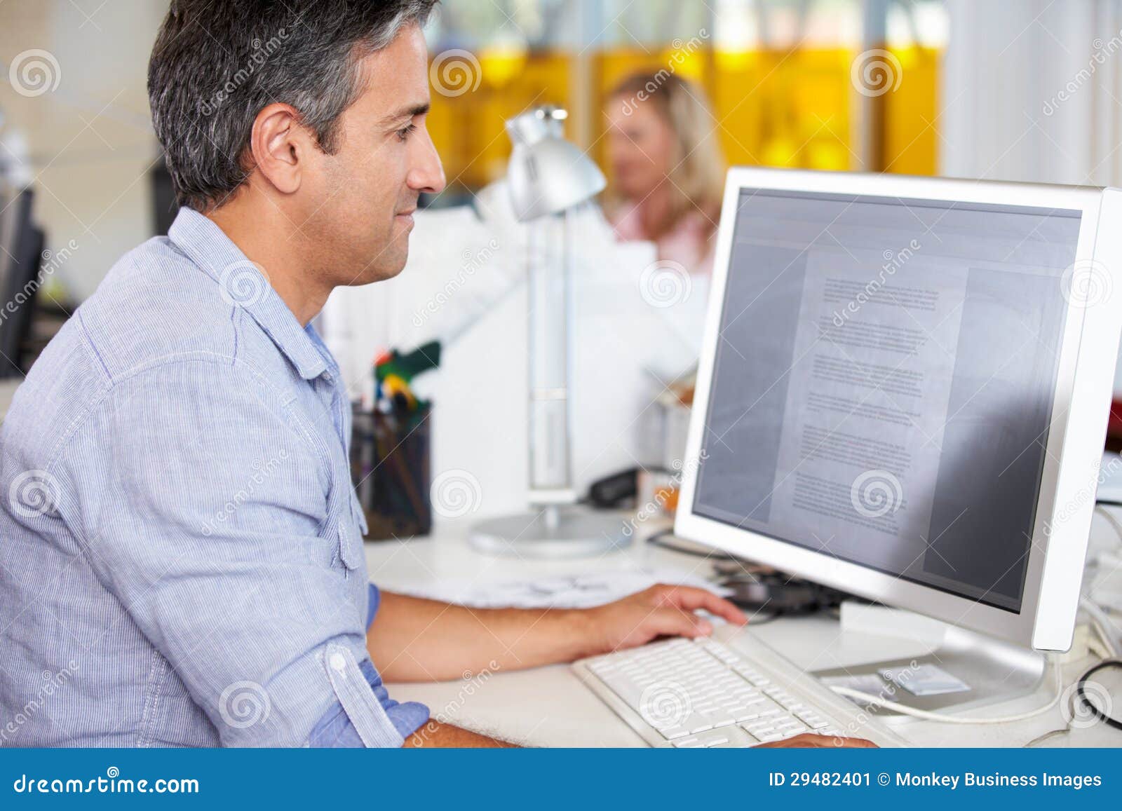 Man Working At Desk In Busy Creative Office Stock Image Image Of