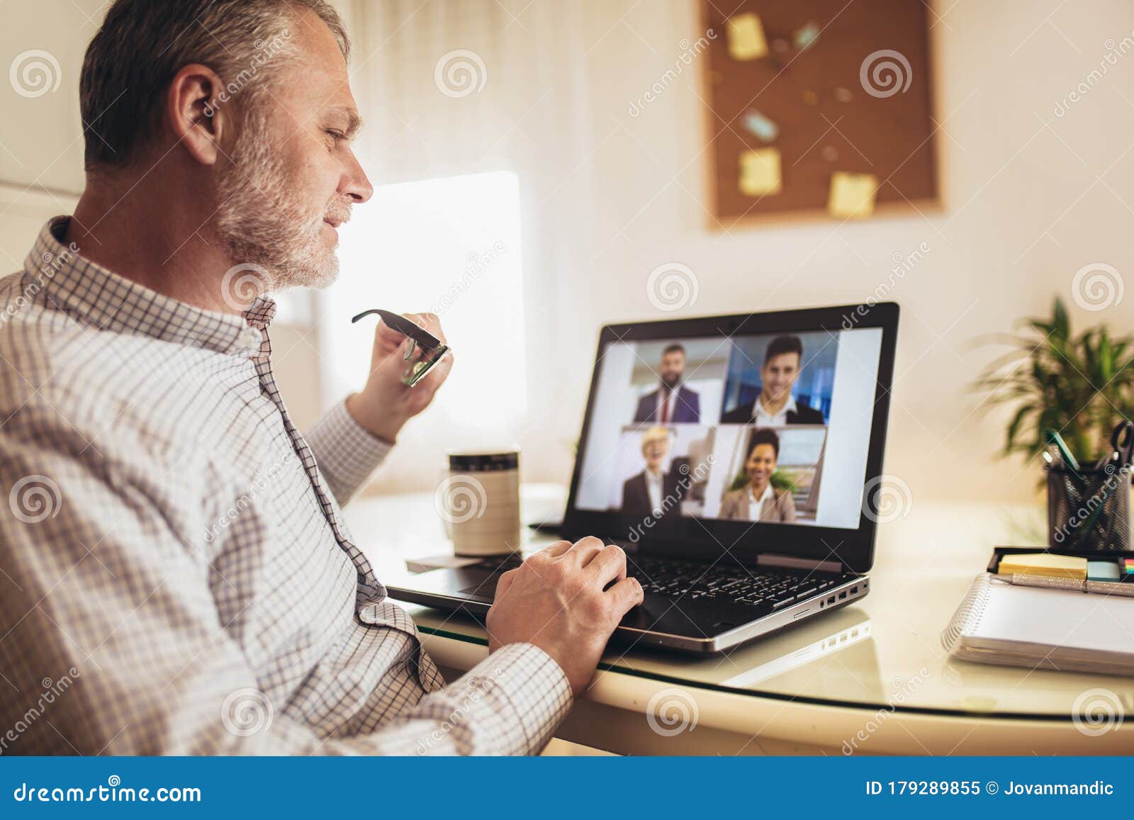 man working from home having online group videoconference