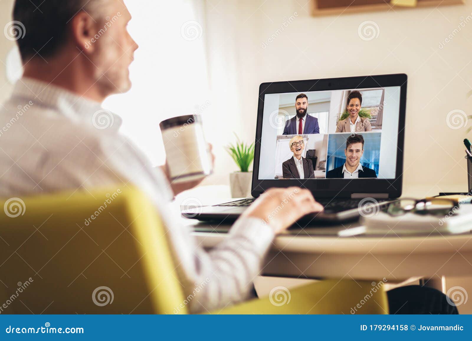 man working from home having online group videoconference