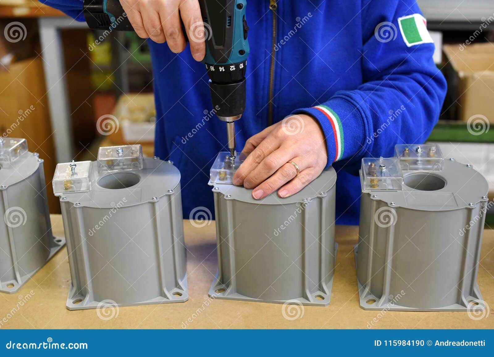 man working with gun at assembly line
