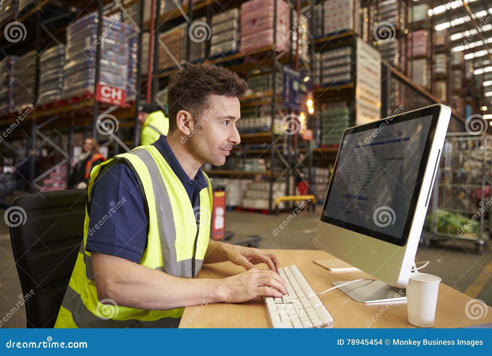 man working in on-site office at a distribution warehouse
