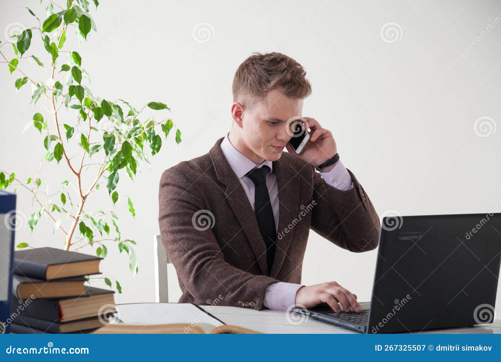 a business man works at a desk in an office space. a man works at a desk in an office space
