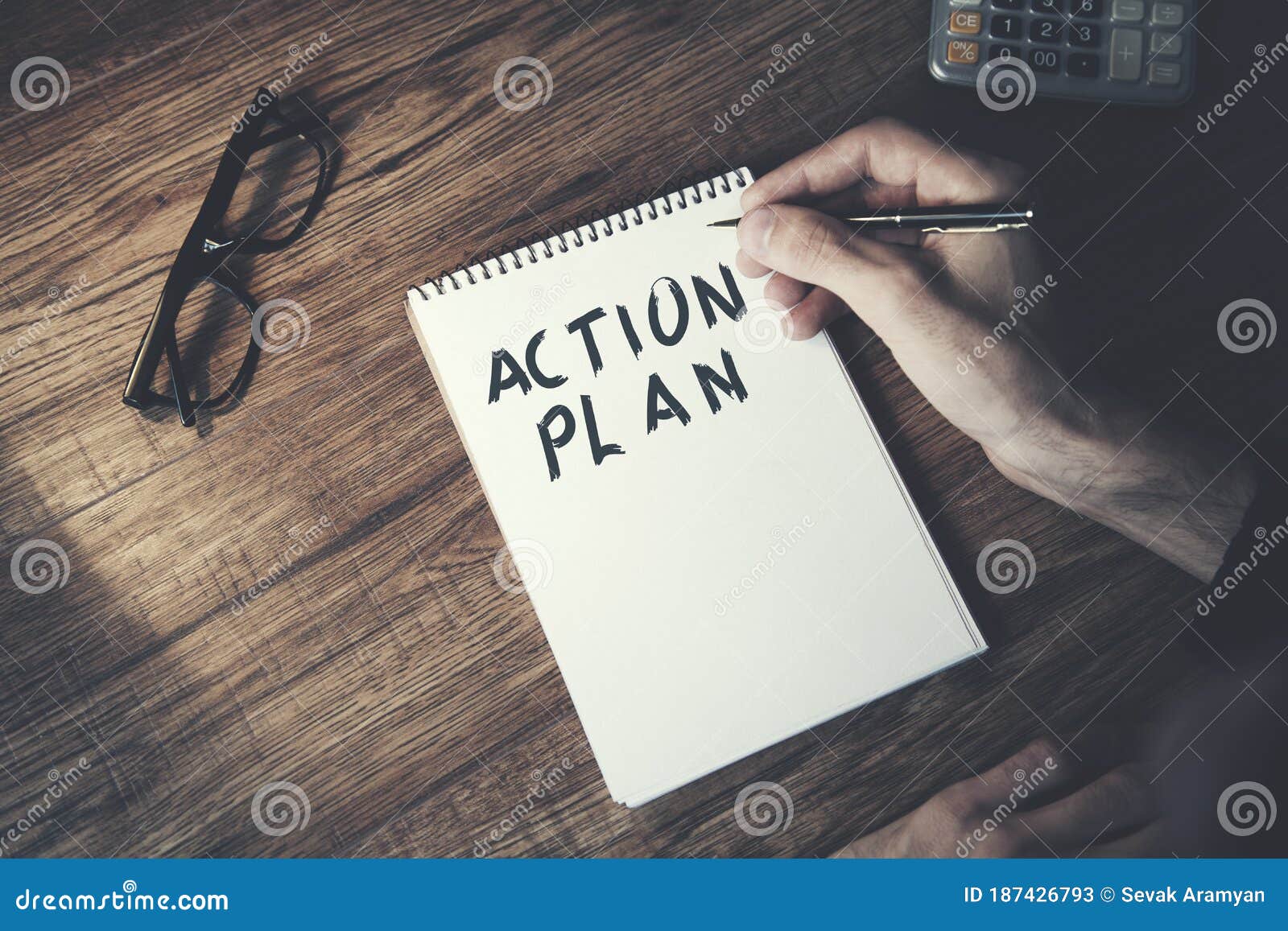 man written action  plan text on notepa