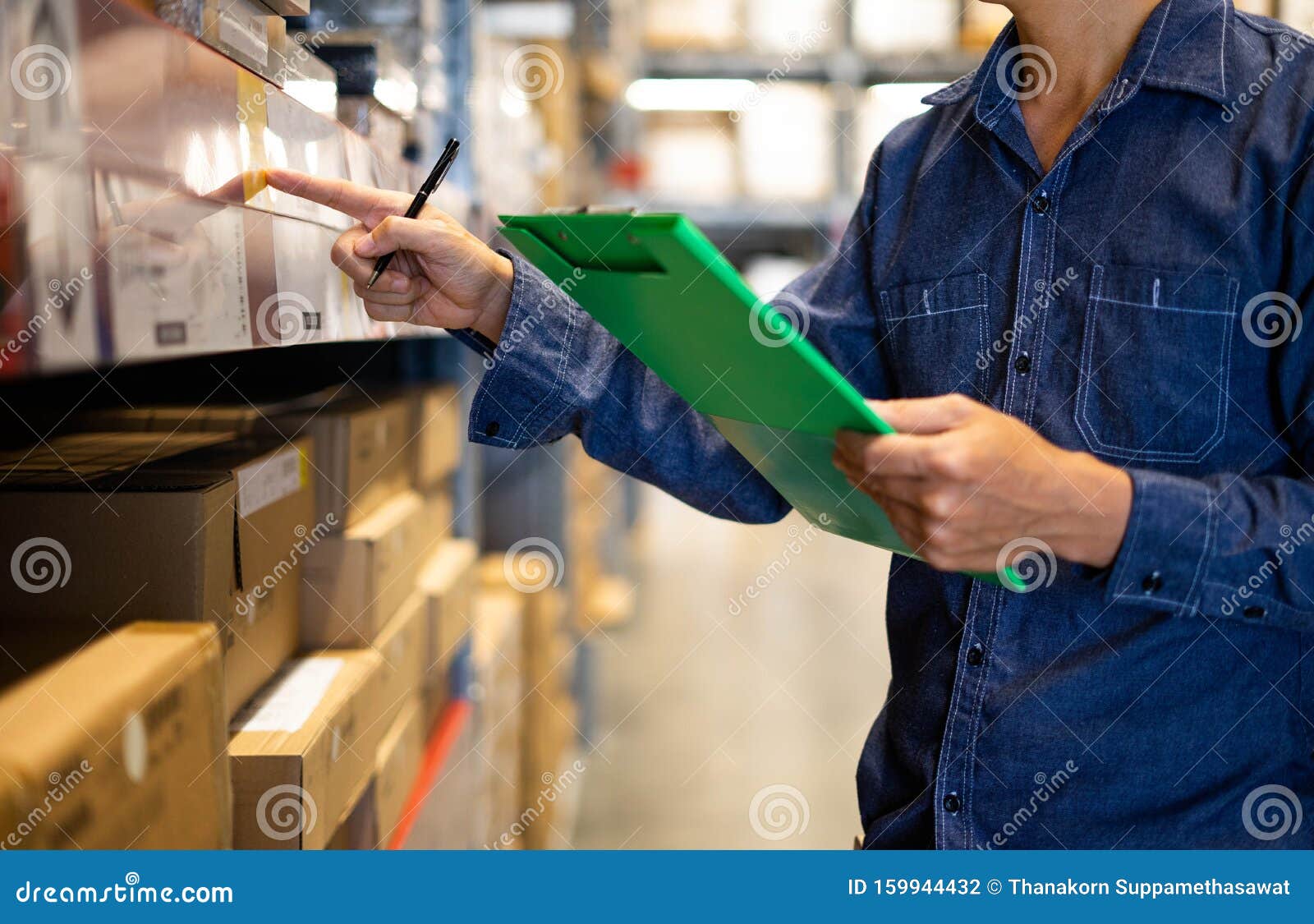 manager man worker doing stocktaking of product management in cardboard box on shelves in warehouse. physical inventory count..