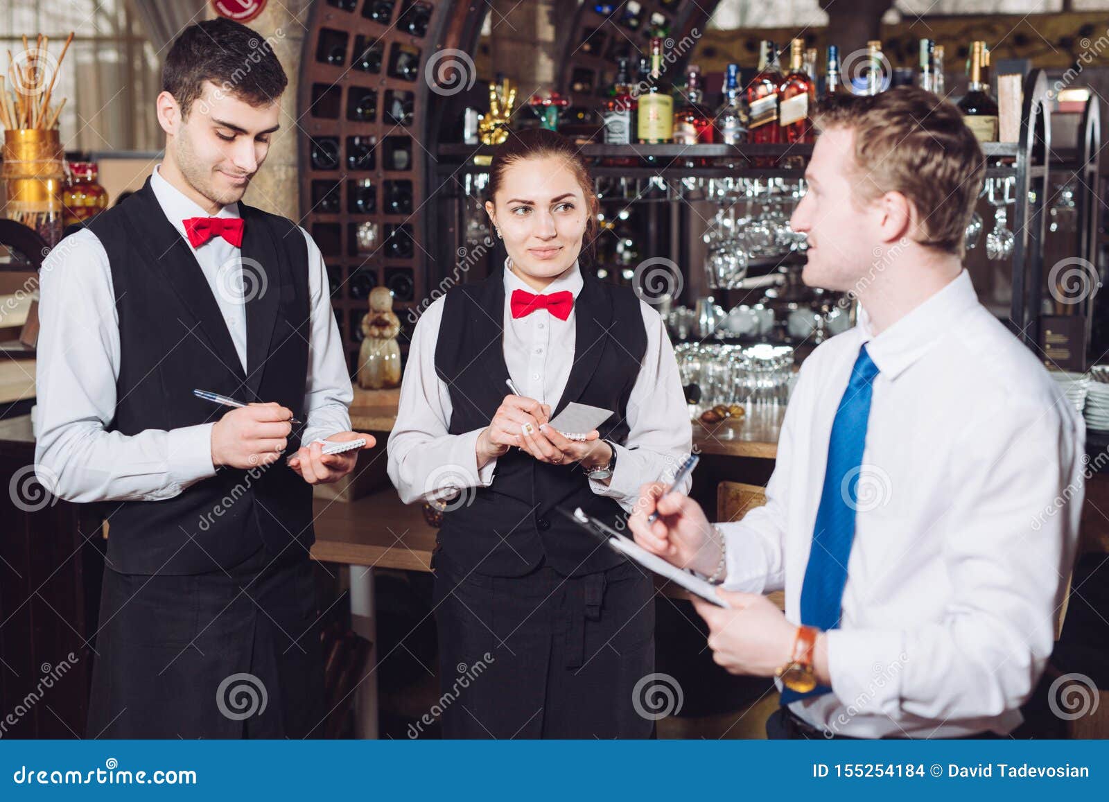 manager`s briefing with the waiters. restaurant manager and his staff