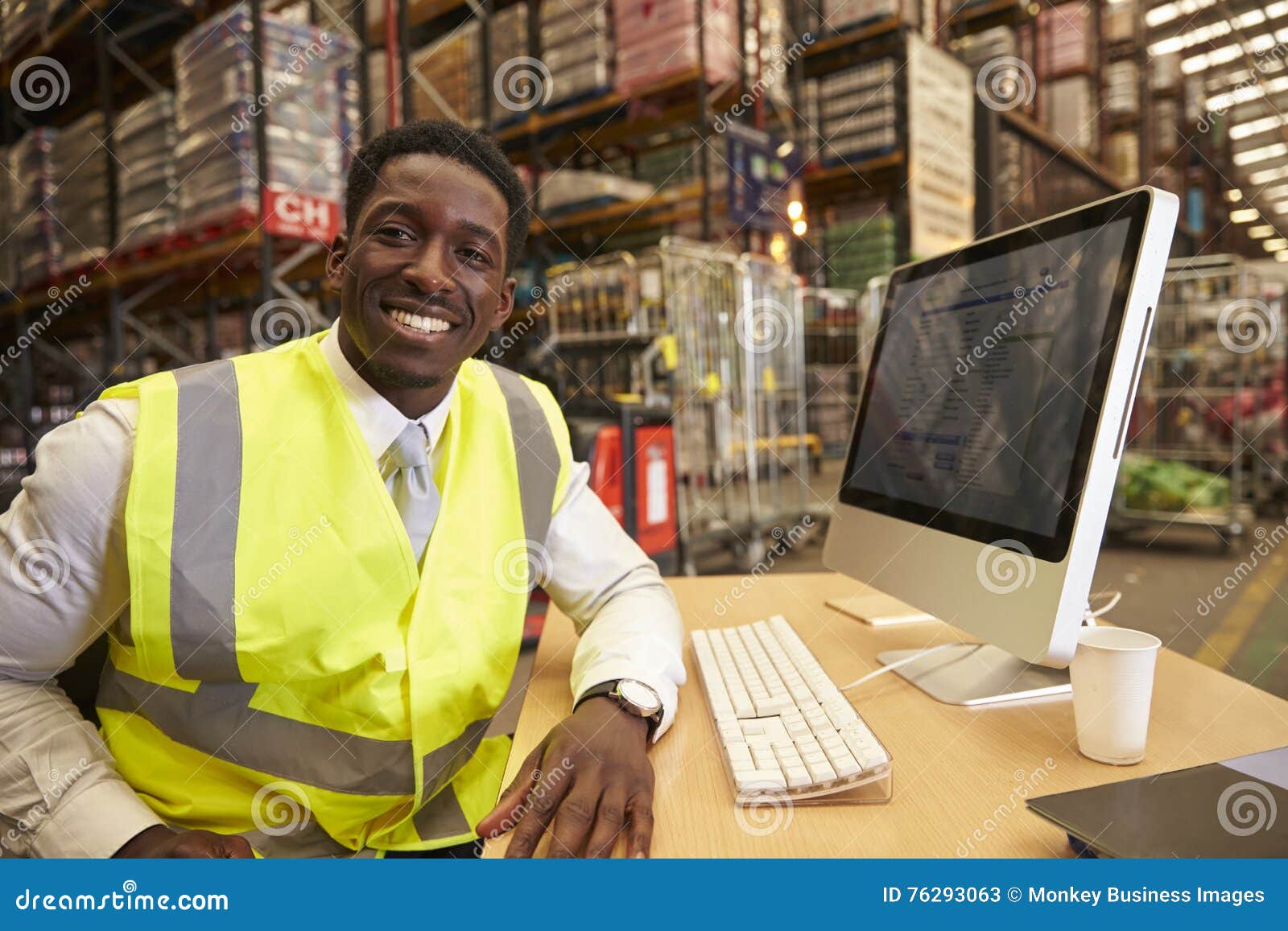 Manager in the onsite Office of a Warehouse Looks To Camera Stock