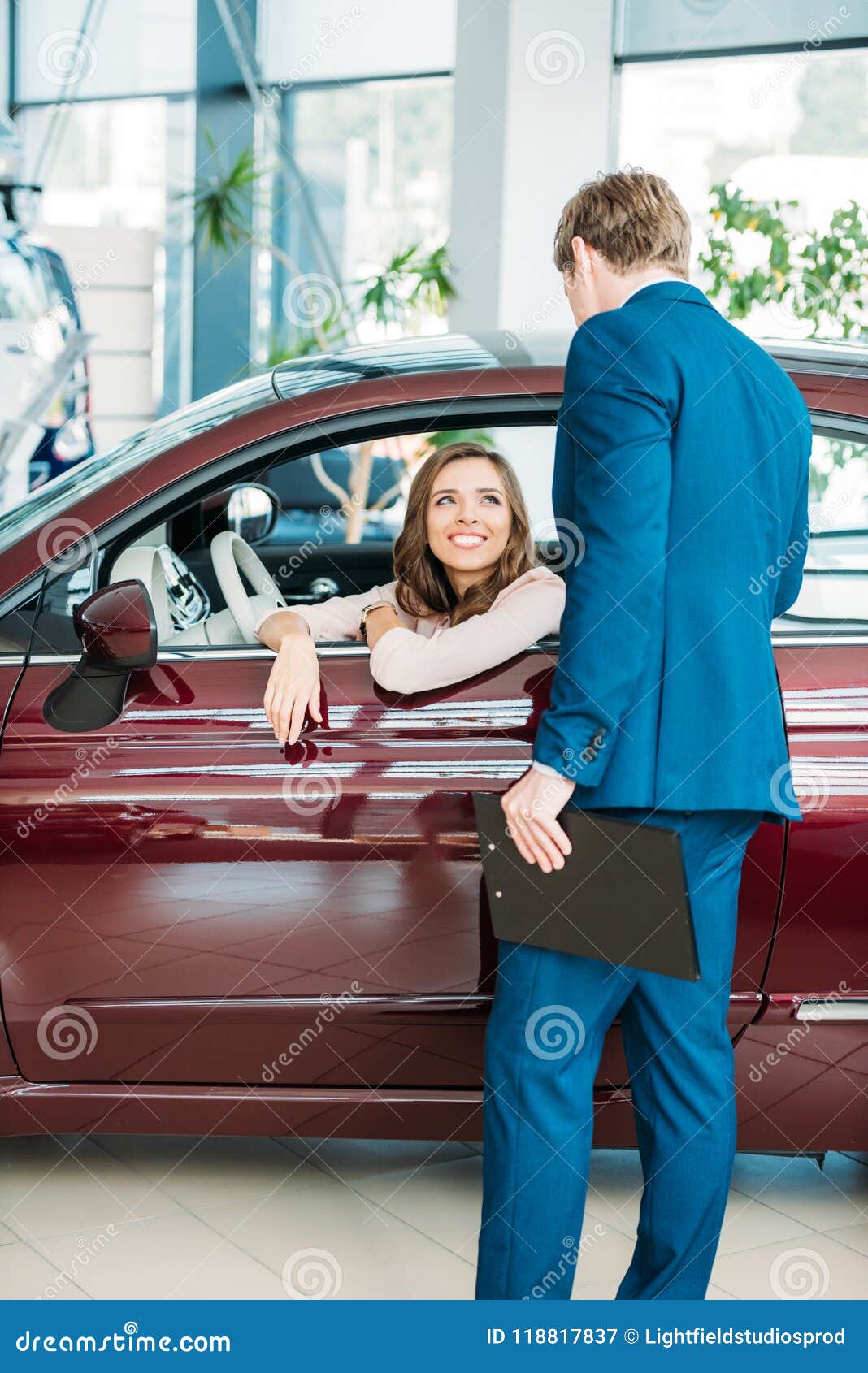 Manager Talking with a Customer after Testdriving a Stock Image