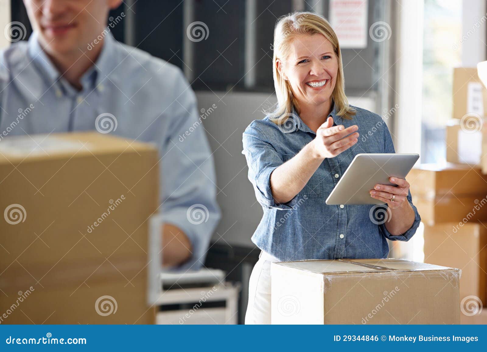 manager using tablet computer in distribution warehouse