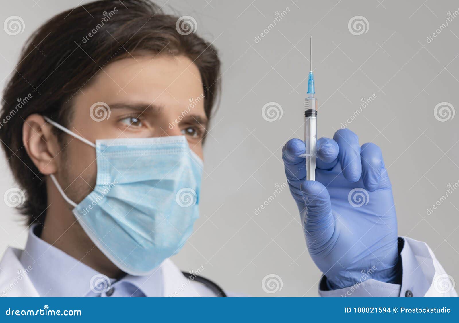 mandatory vaccination concept. closeup of male doctor holding syringe with vaccine