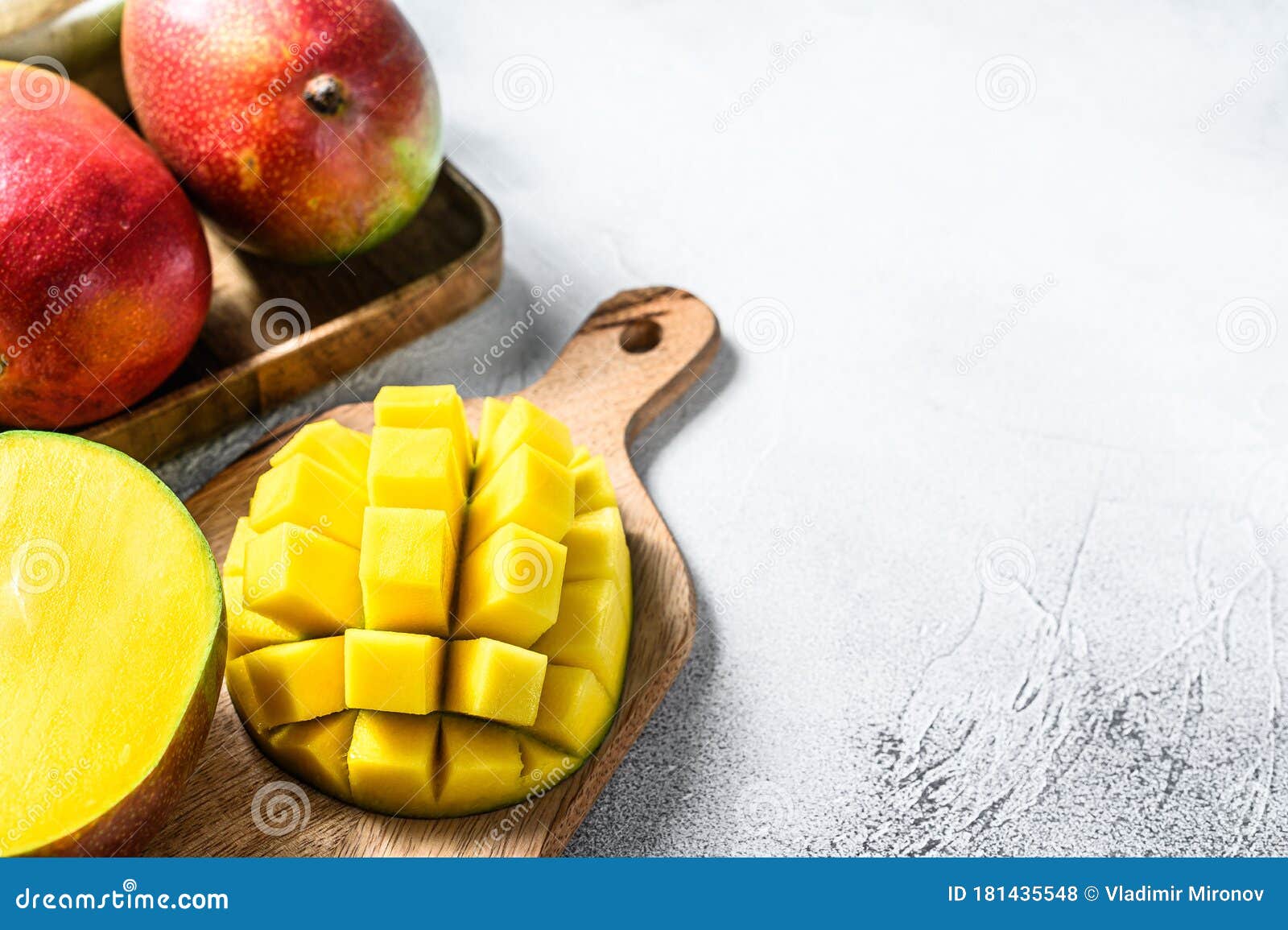 Mango Fruit Cut into Cubes on a Cutting Board. Gray Background. Top