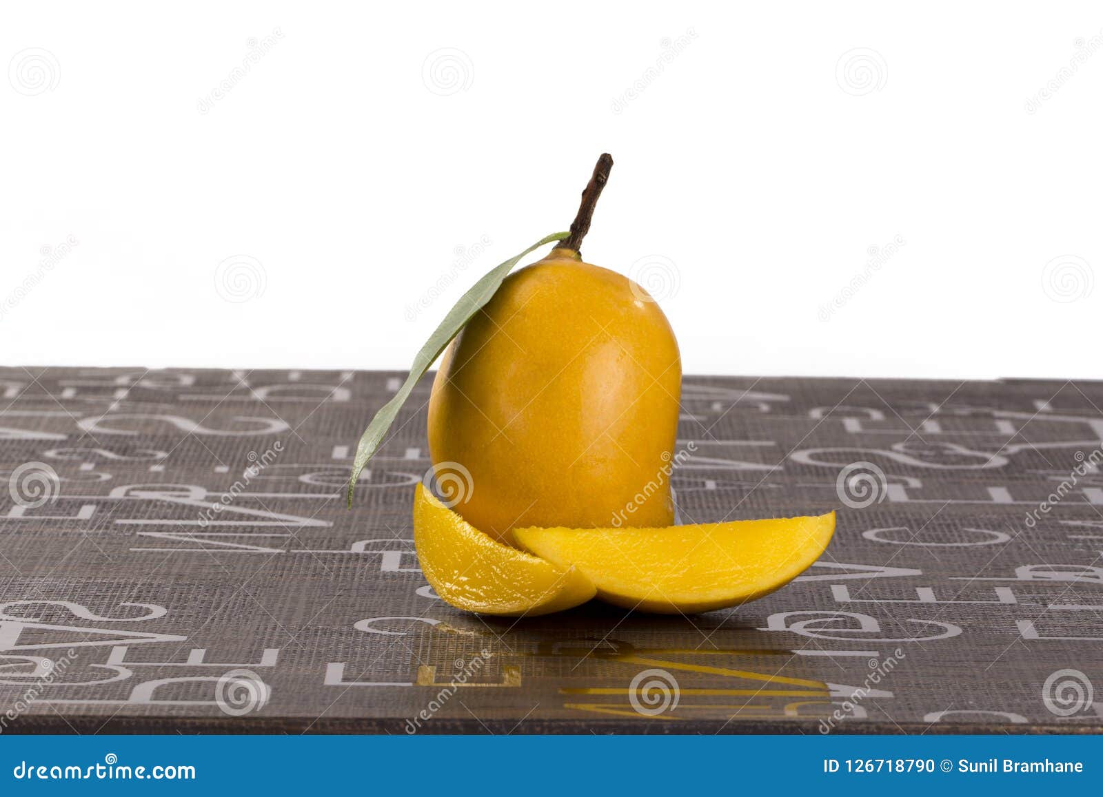 Mango with Some Cut Slices on Brown Background Stock Photo - Image of ...