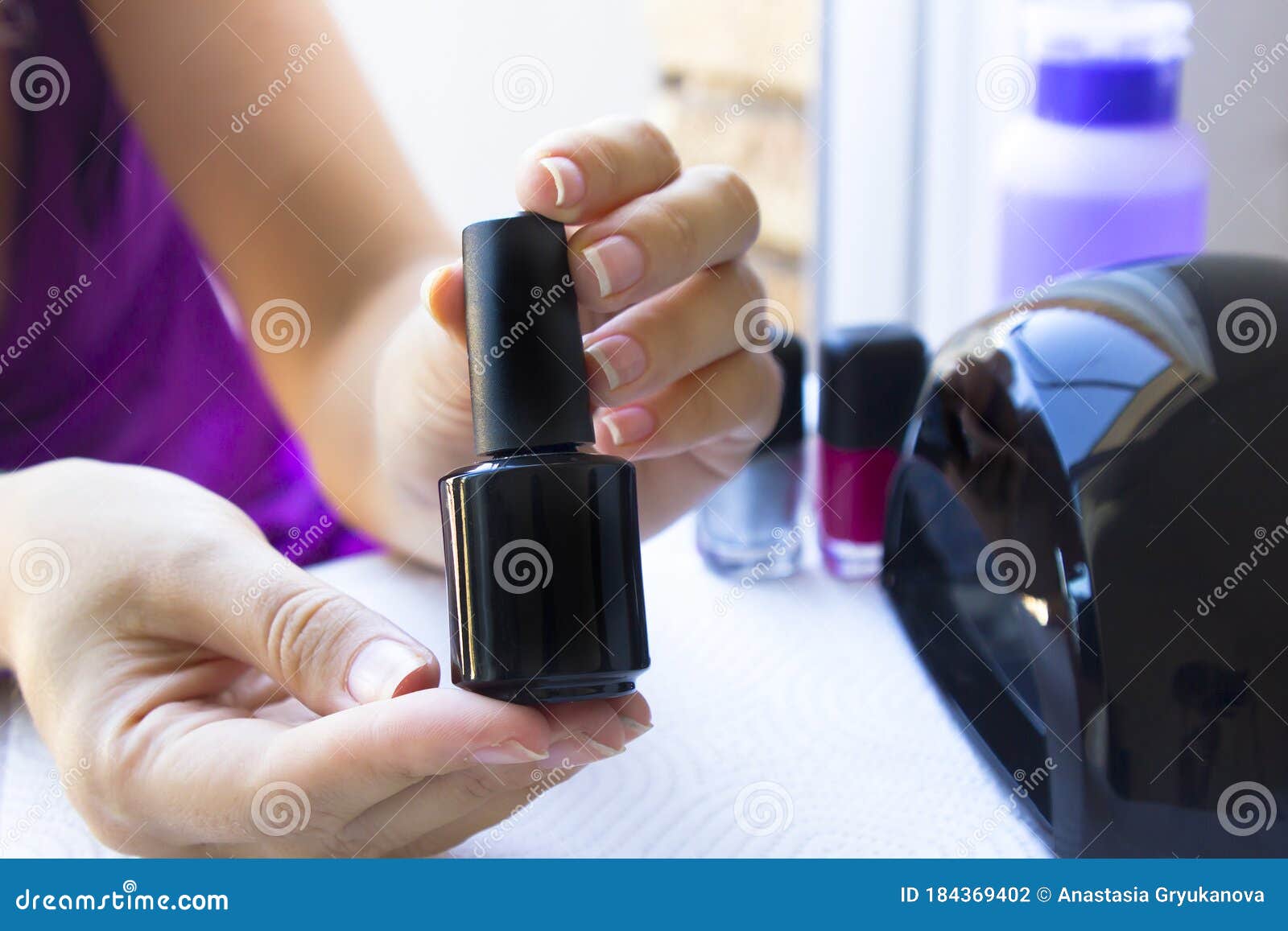 Download Manicure Beautiful Woman Hands Hold And Show A Black Nail Polish Bottle Stock Photo Image Of Care Manicurist 184369402