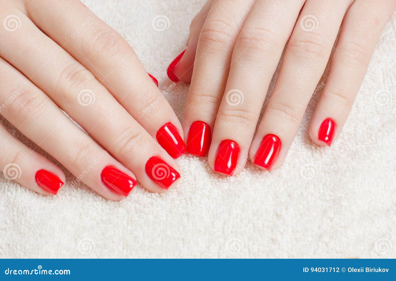 manicure - beauty treatment photo of nice manicured woman fingernails with red nail polish.