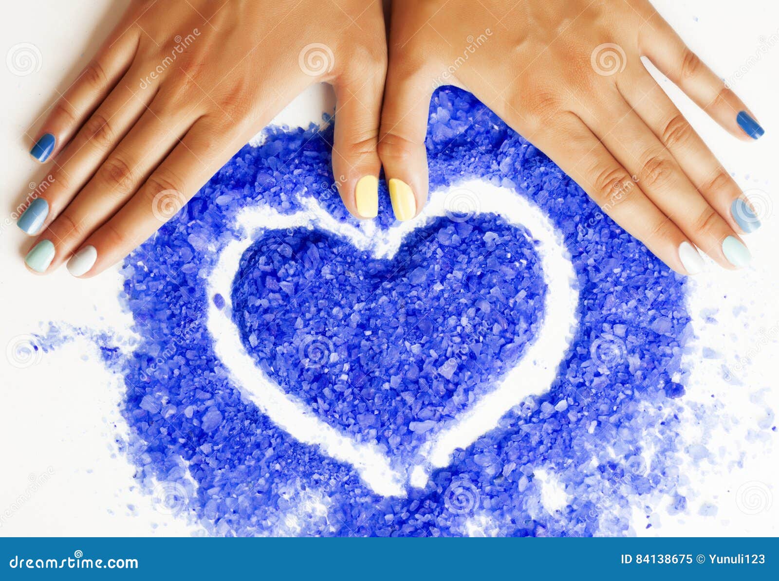 manicure with blue nails and seasalt close up like heart, love f