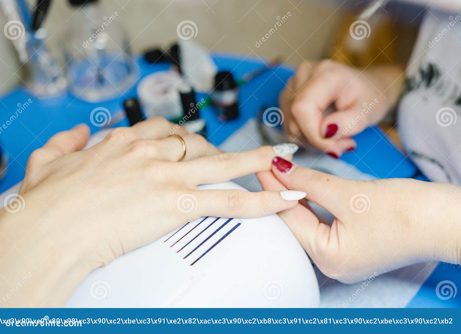 manicure. the woman cleans and paints nails. the woman processes nails on hands a varnish. shelak. gel, a varnish, placing acryle
