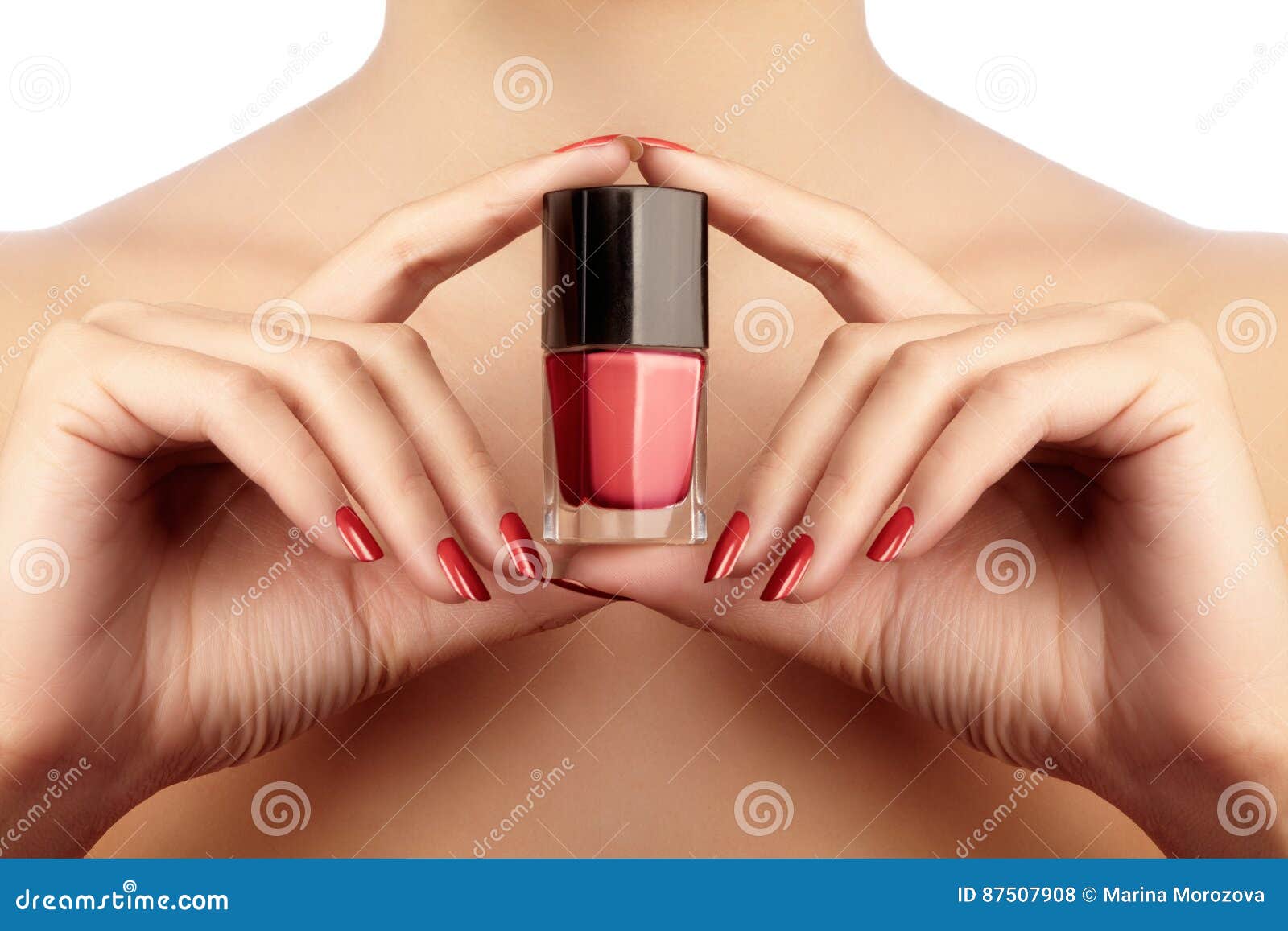 manicured nails with red nail polish. manicure with bright nailpolish. fashion manicure. shiny gel lacquer in bottle