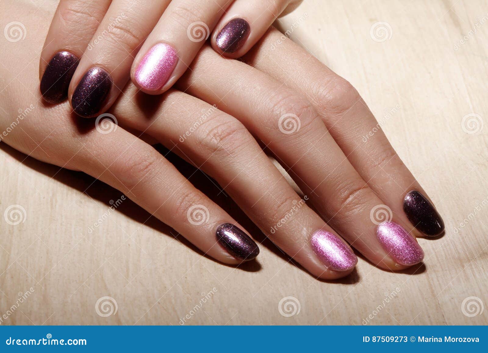 manicured nails with shiny nail polish. manicure with bright nailpolish. fashion art manicure with shiny gel lacquer
