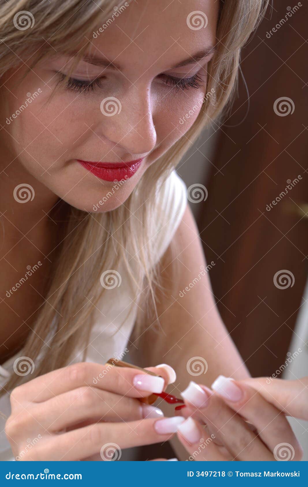 manicurist applies nail polish
