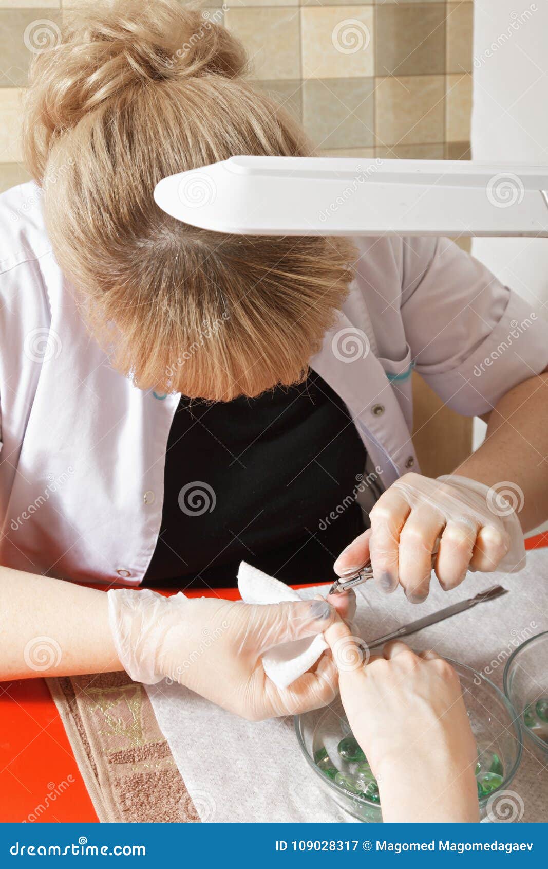 manicurist removing cuticles