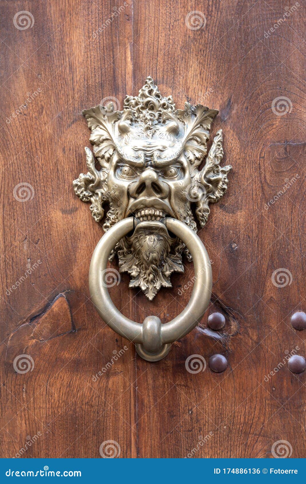 door handle with metal mask depicting the devil