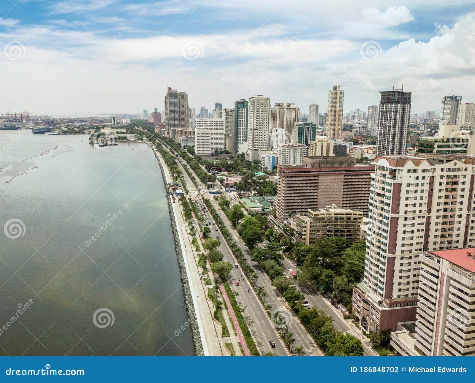 manila, philippines - roxas boulevard, manila skyline and manila bay. tall residential condominiums line the famous